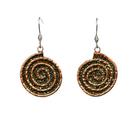 Spiral drop earrings handcrafted from reclaimed copper pipes with natural pyrite accents in San José del Cabo.