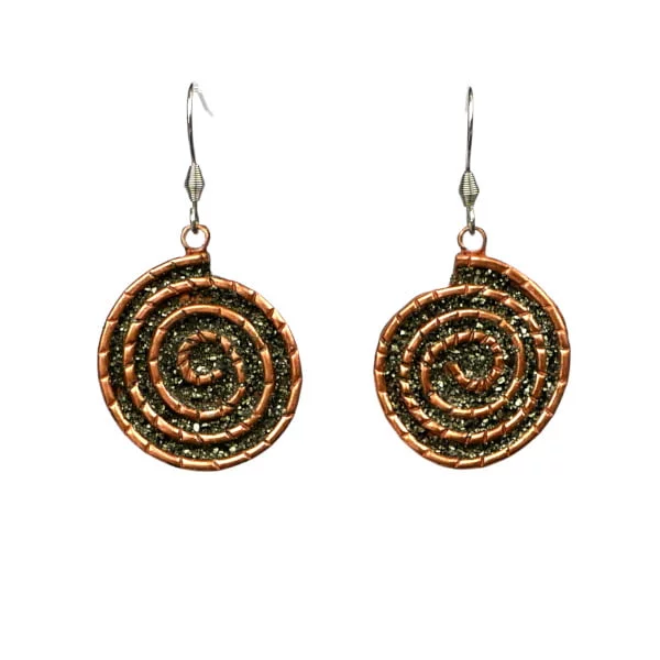 Spiral drop earrings handcrafted from reclaimed copper pipes with natural pyrite accents in San José del Cabo.